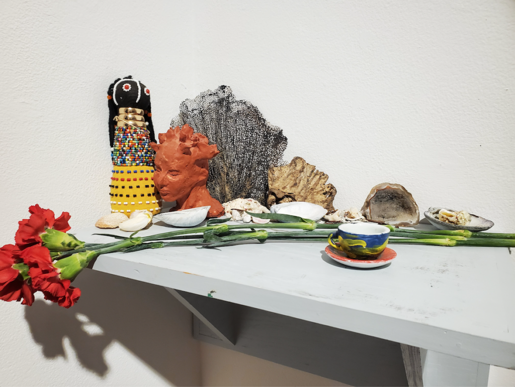 A shelf altar in Smith Gallery for "The Divine Feminine: Black and Taíno Sacred Bodies." Photo by Shabana Gupta.