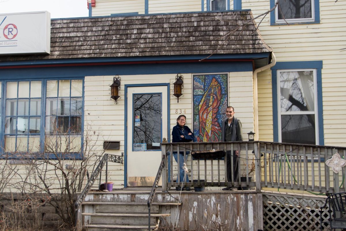 From left: Laura Fendt and Kamal Hammouda pose in front of their future co-op housing project at 834 Park St. 