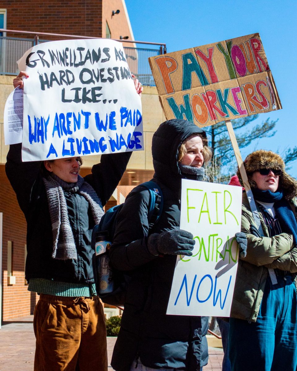 Members of the Union of Grinnell Student Dining Workers hold up signs during a "Back to Bargaining" rally on Feb. 28, 2024.