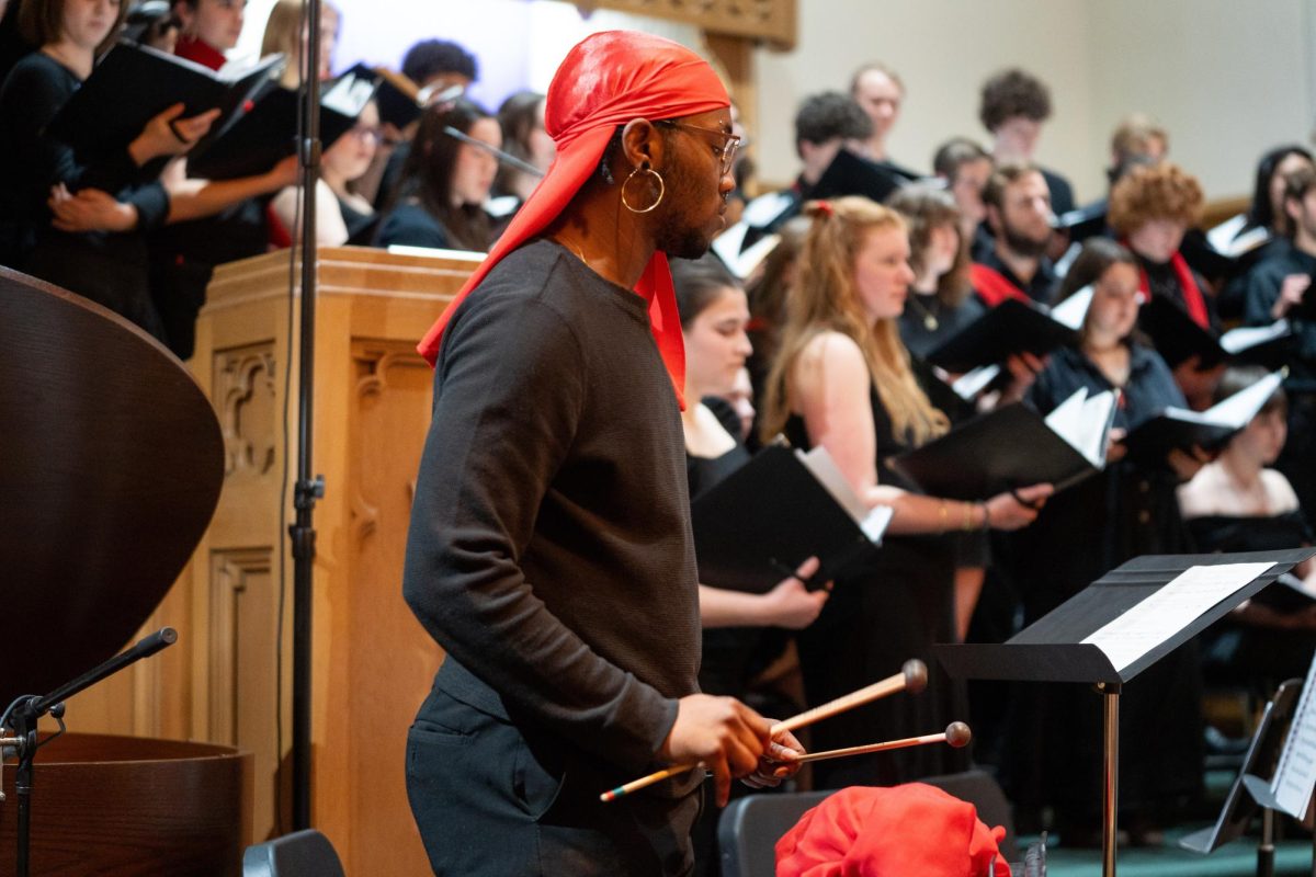 Jadyn Al-Fatah `27 plays an instrument during the Grinnell Singers tour at Pilgrim Lutheran Church, Chicago on Tuesday, Mar. 11.