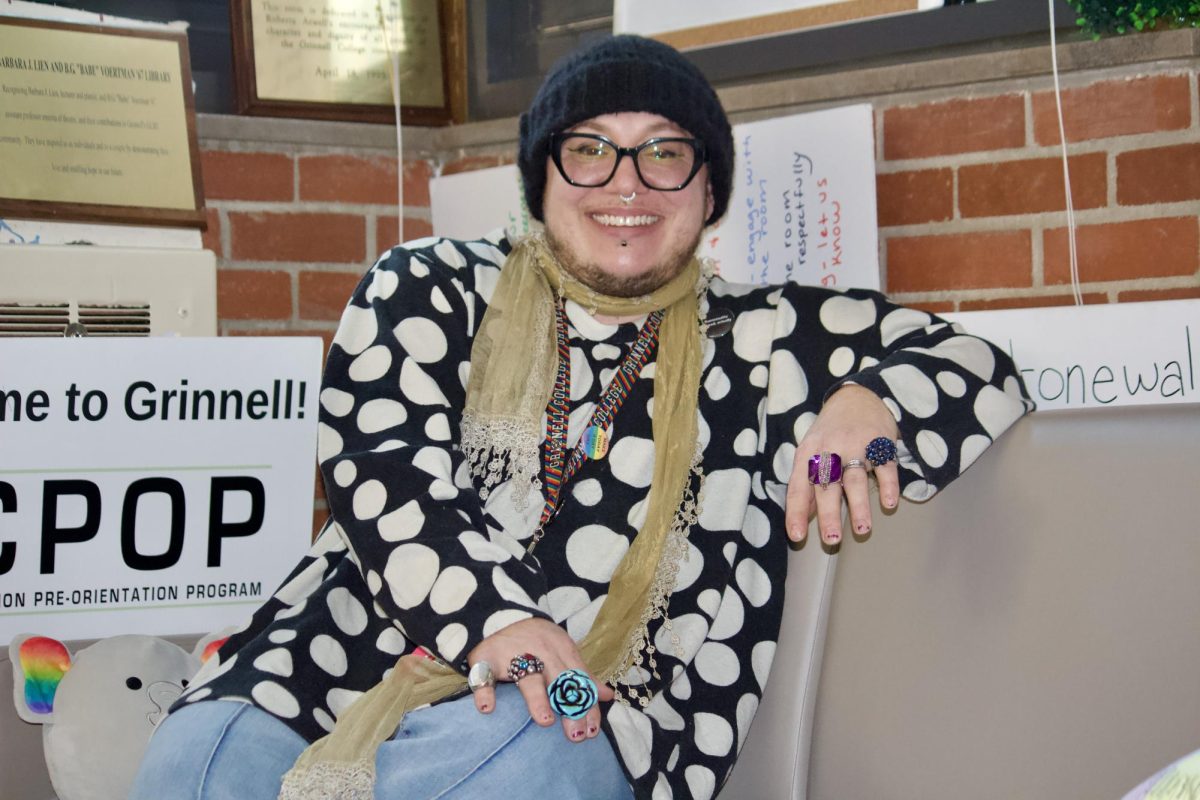 Micho Adler, Assistant Director of Intercultural Affairs and LGBTQIA+ Student Specialist sits in the Stonewall Resource Center (SRC).