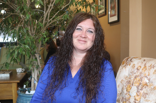 Kate Slater, executive director of the Grinnell Housing Authority, poses for a portrait inside of Saint's Rest Coffeehouse