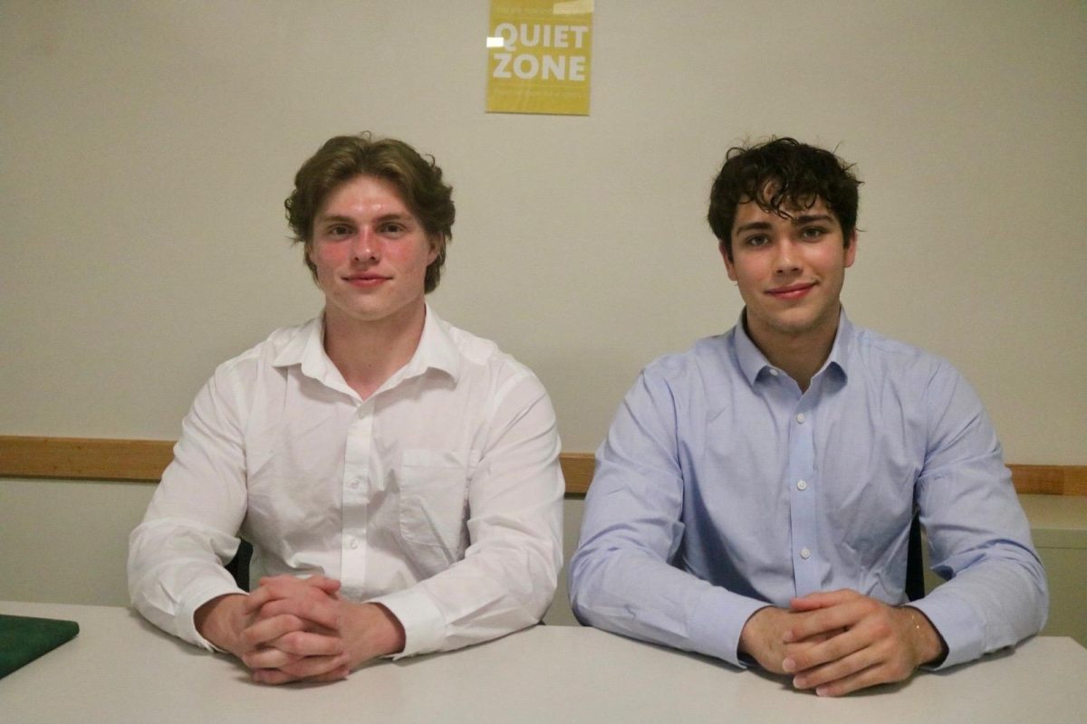 From left: Peyton Williams `27 and Alex Smith `27 pose for a photo in Burling Library.